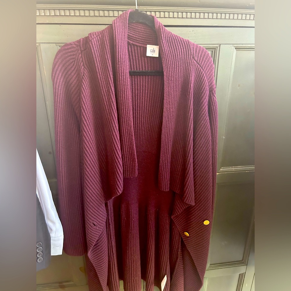 This is a long Cabi cárdigan. Size medium. Burgundy in color.